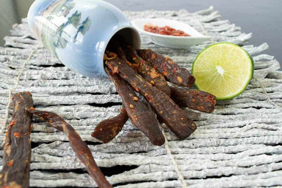 Chili Lime jerky with lime and chili garlic sauce in jar