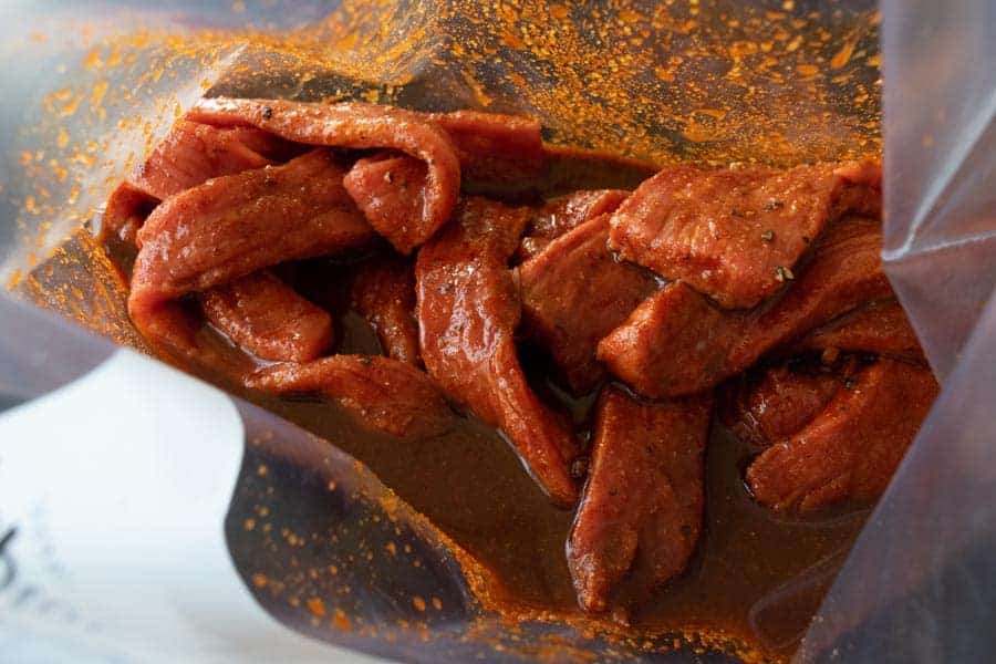 Habanero Tabasco beef jerky strips marinating in ziplock bag