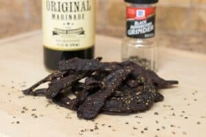 Elk jerky with marinade and ground black pepper