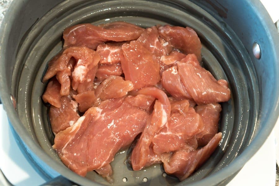 Sweet Maple Pork Jerky in Colander after straining marinade
