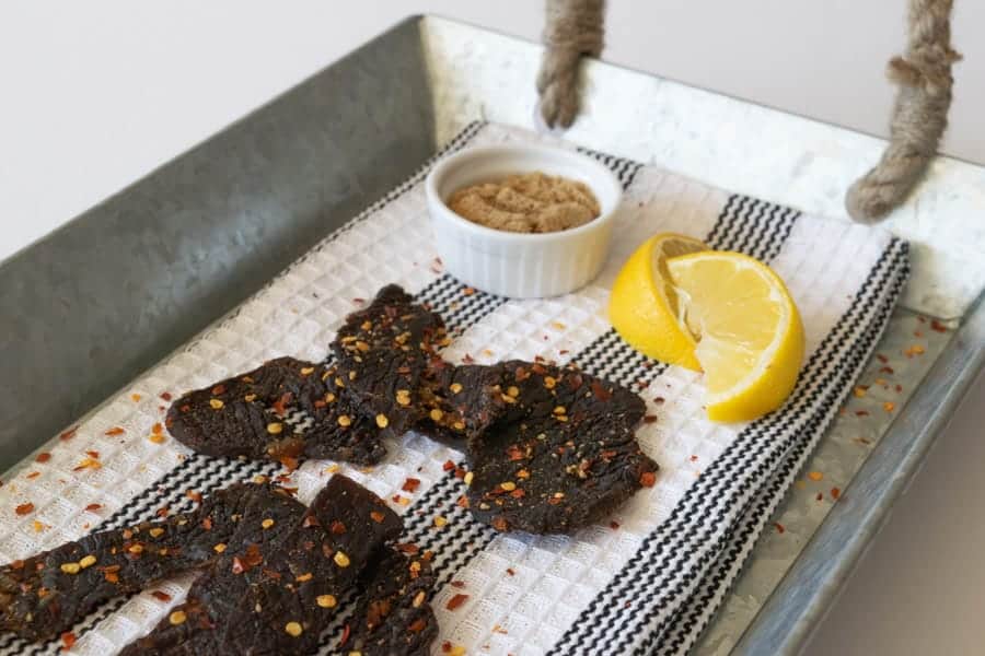 Simply Sweet Beef Jerky on tray with lemons and brown sugar