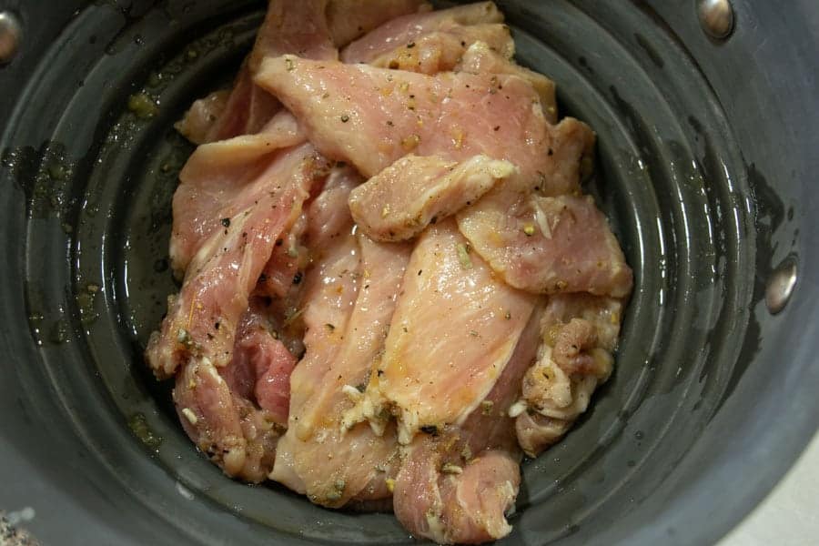 Apple sage pork jerky straining in colander