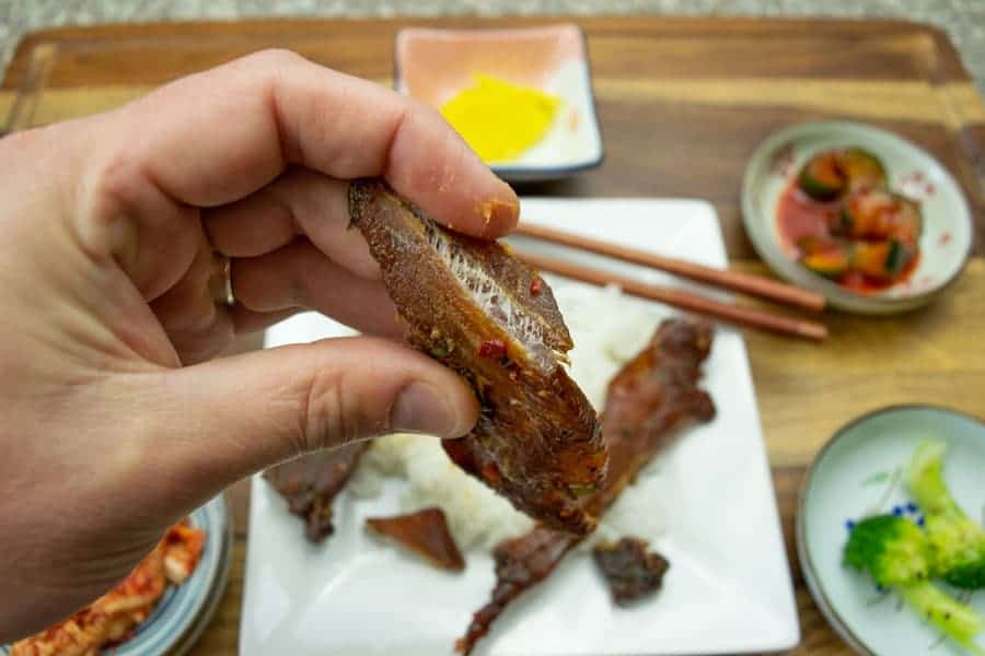 korean bbq pork jerky bent showing white fibers of meat