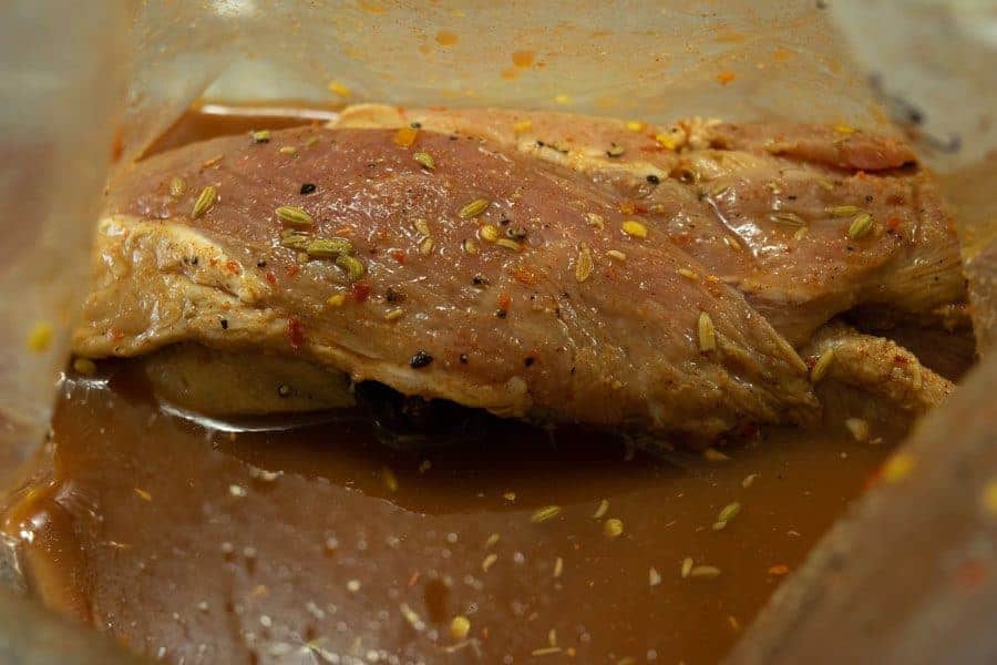 Italian pork jerky marinating in ziplock bag