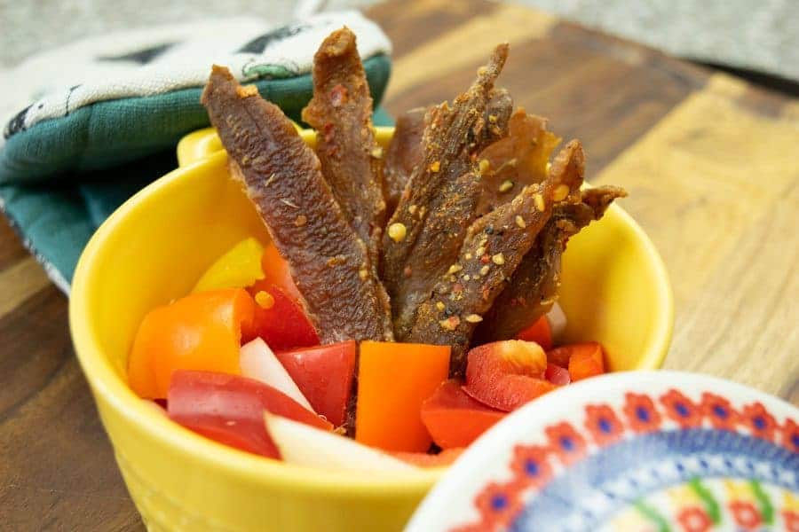 Italian Pork Jerky in dish with peppers and onions