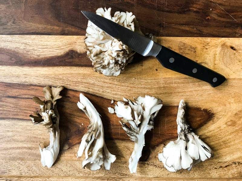Sliced Maitake Mushrooms, knife and cutting board