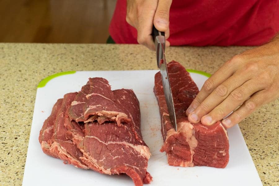 Slicing Beef Bottom Round for jerky on cutting board