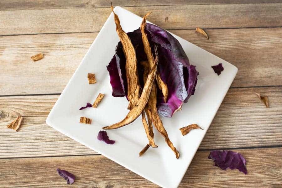 Eggplant jerky on red cabbage on white plate