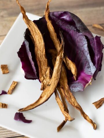 Eggplant jerky on red cabbage on white plate