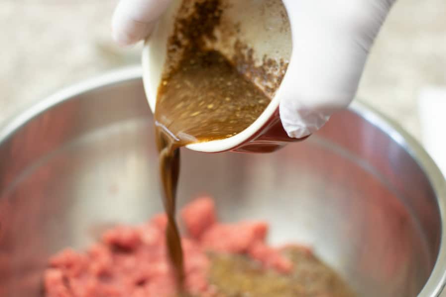 pouring marinade into ground meat