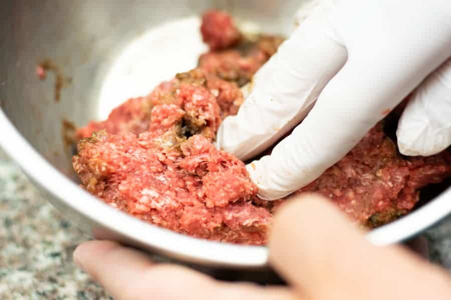 mixing marinade into ground meat by hand