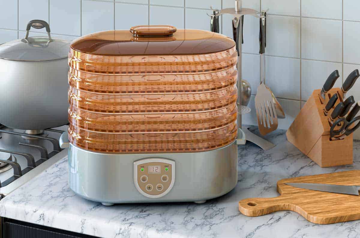 Dehydrator on counter with cutting board and knives