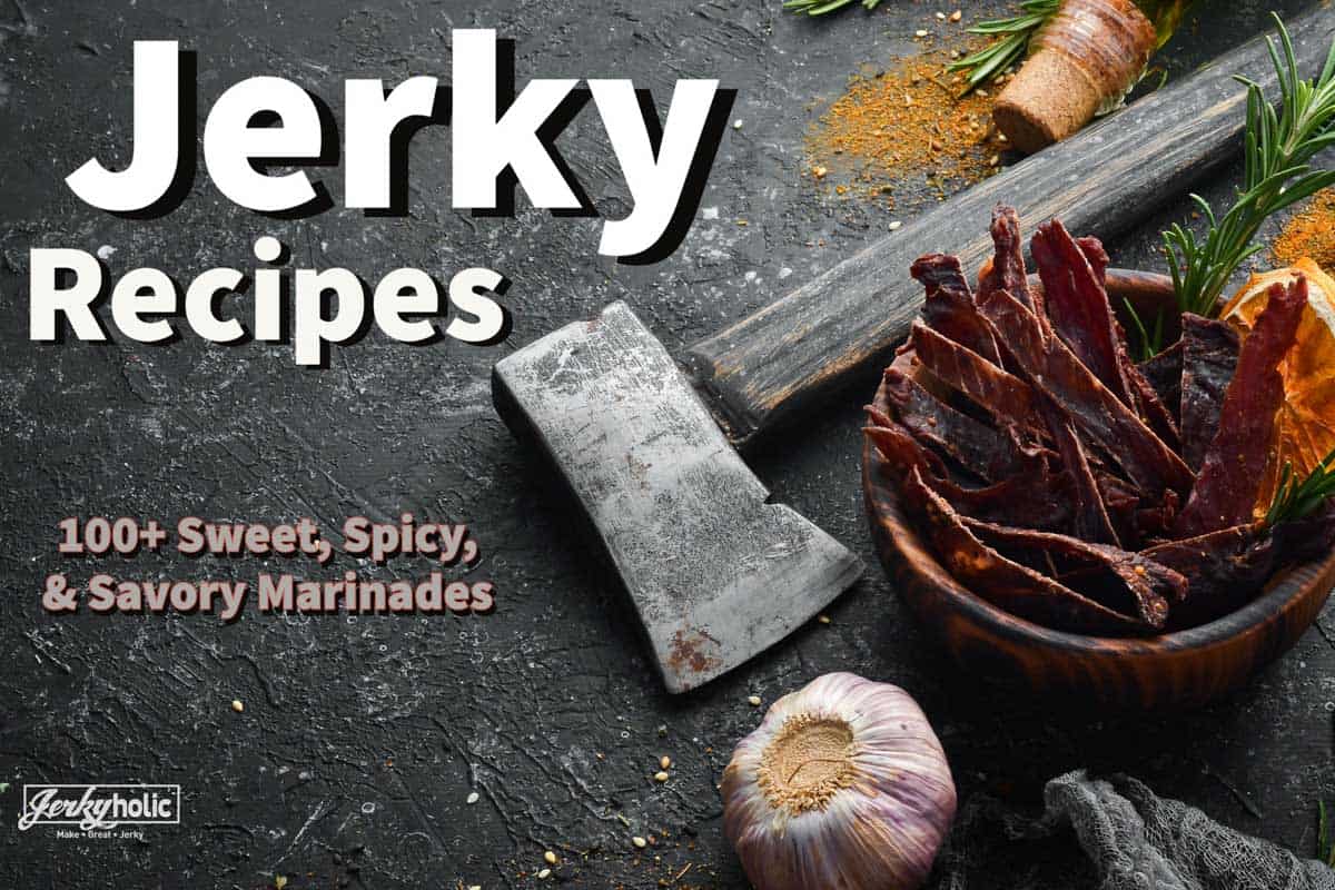 Beef jerky in bowl with an ax and garlic on slate background