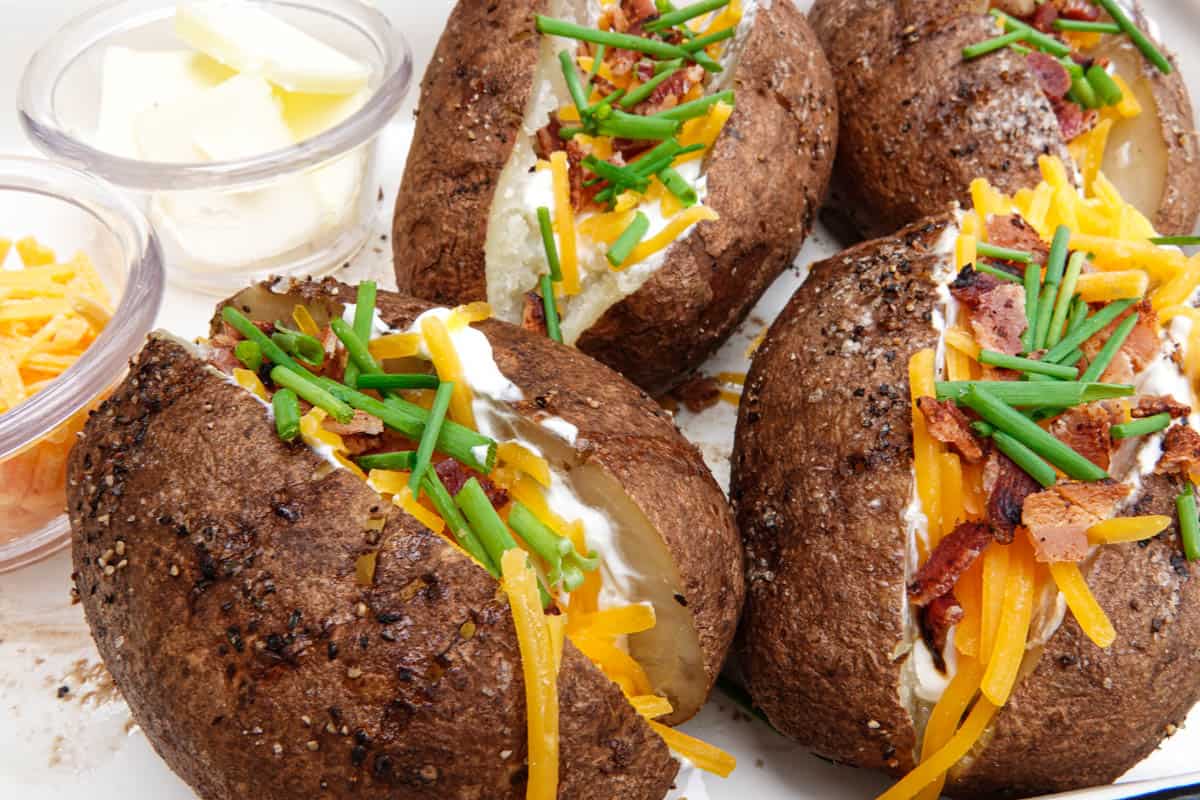 Loaded Baked potatoes with butter and cheese in dish
