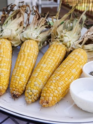Corn on plate with salt and pepper