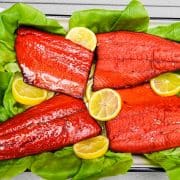smoked salmon on a bed of lettuce with lemon slices