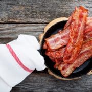 Bacon in frying pan with towel