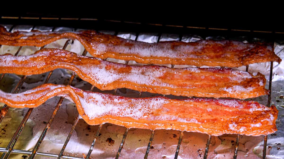 Cooked bacon on smoker rack