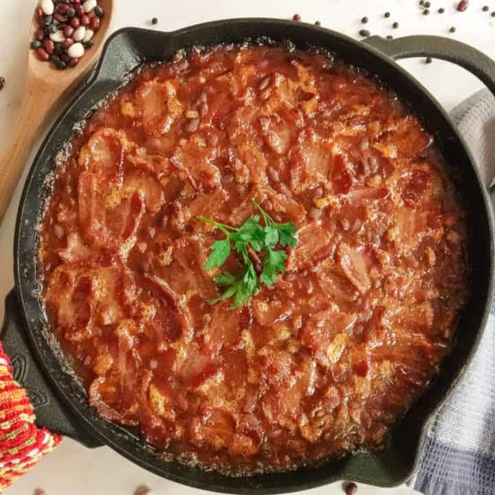 Baked beans in cast iron pan with hand towel