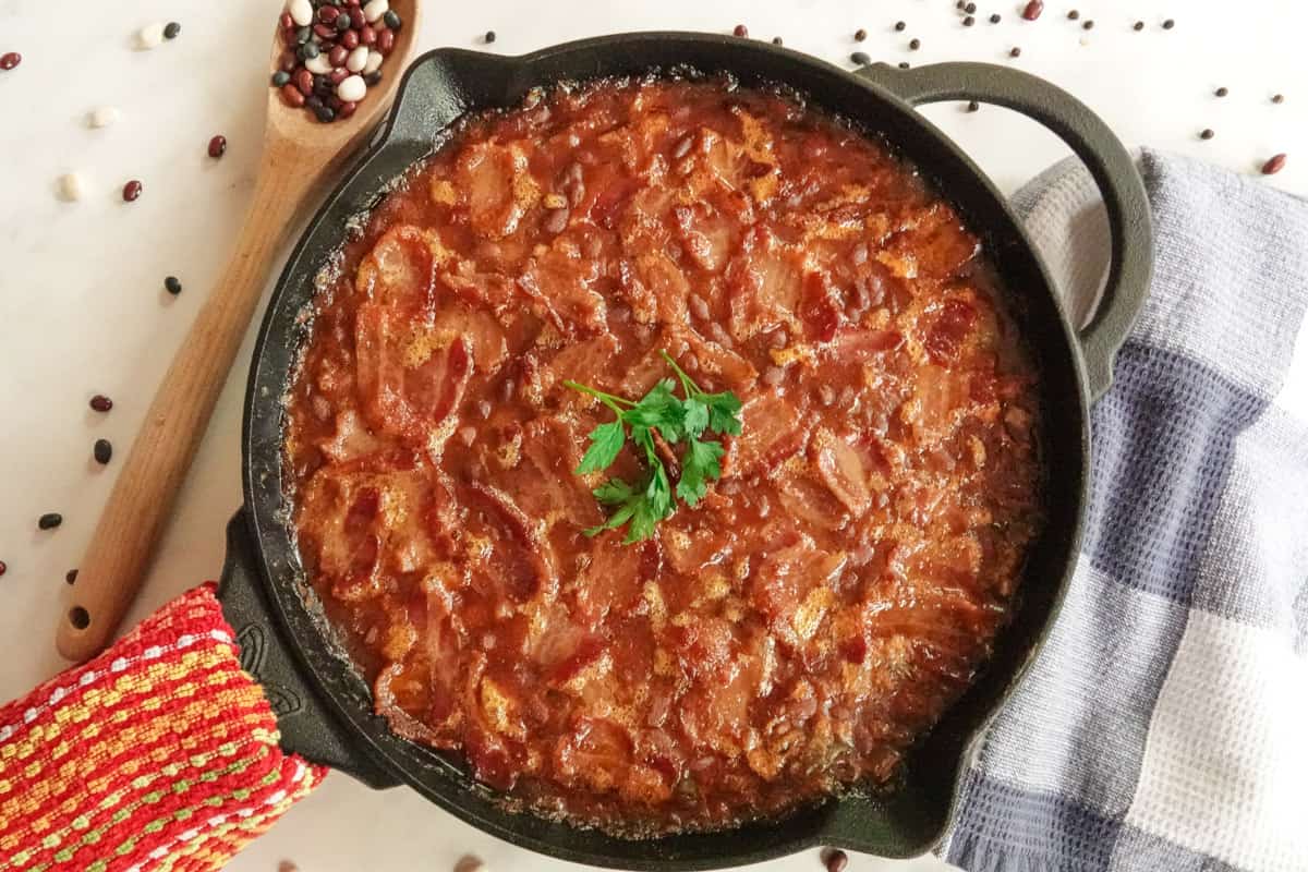 Baked beans in cast iron pan with hand towel