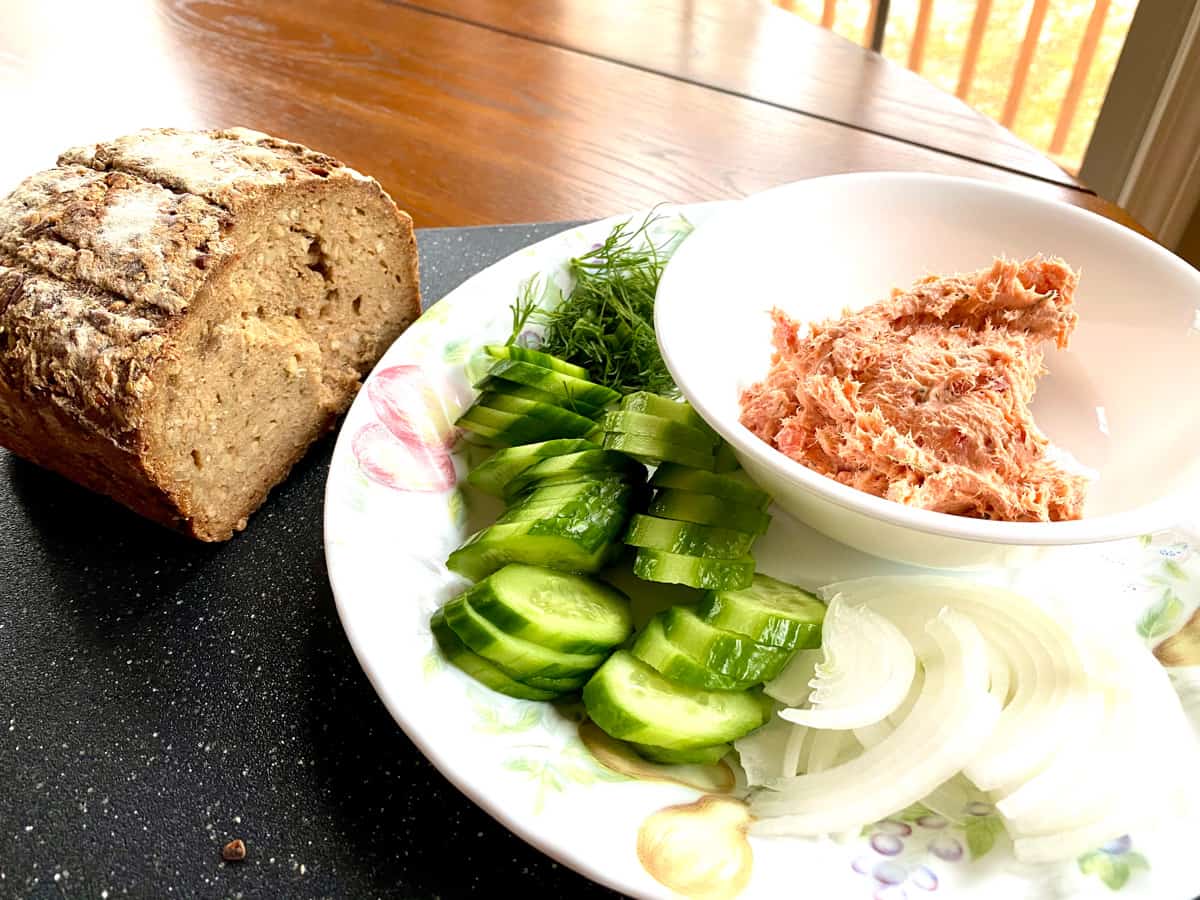Salmon dip platter with cucumbers and onions and seeded bread