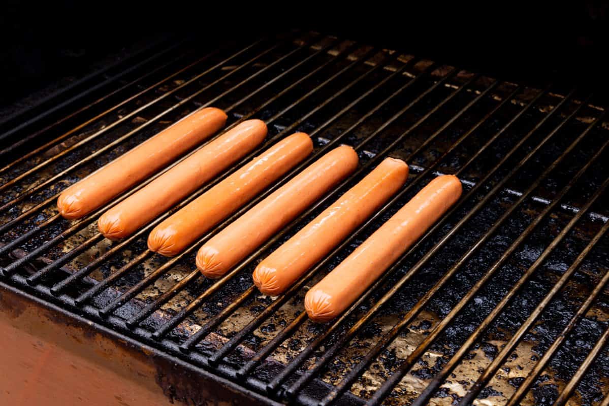 Six hot dogs on grill. 