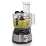 Food processor with guacamole inside with white background.