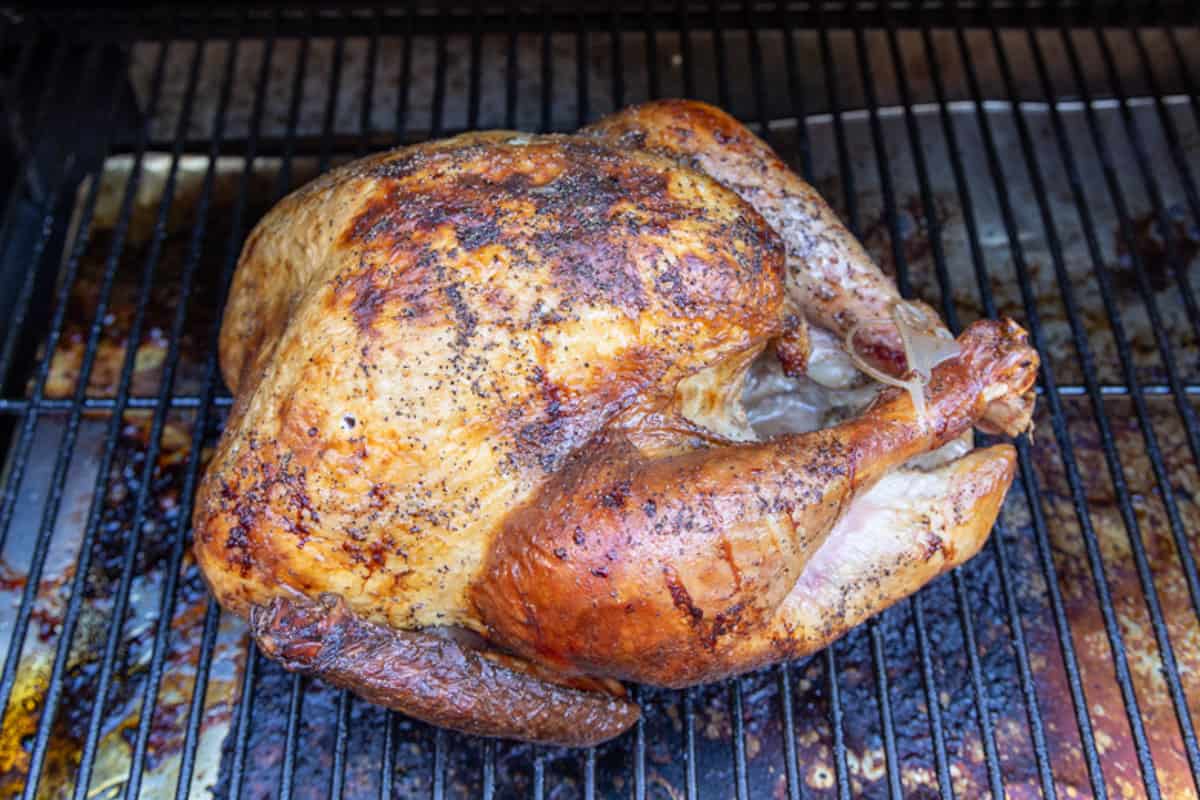 Turkey being smoked on a grill.