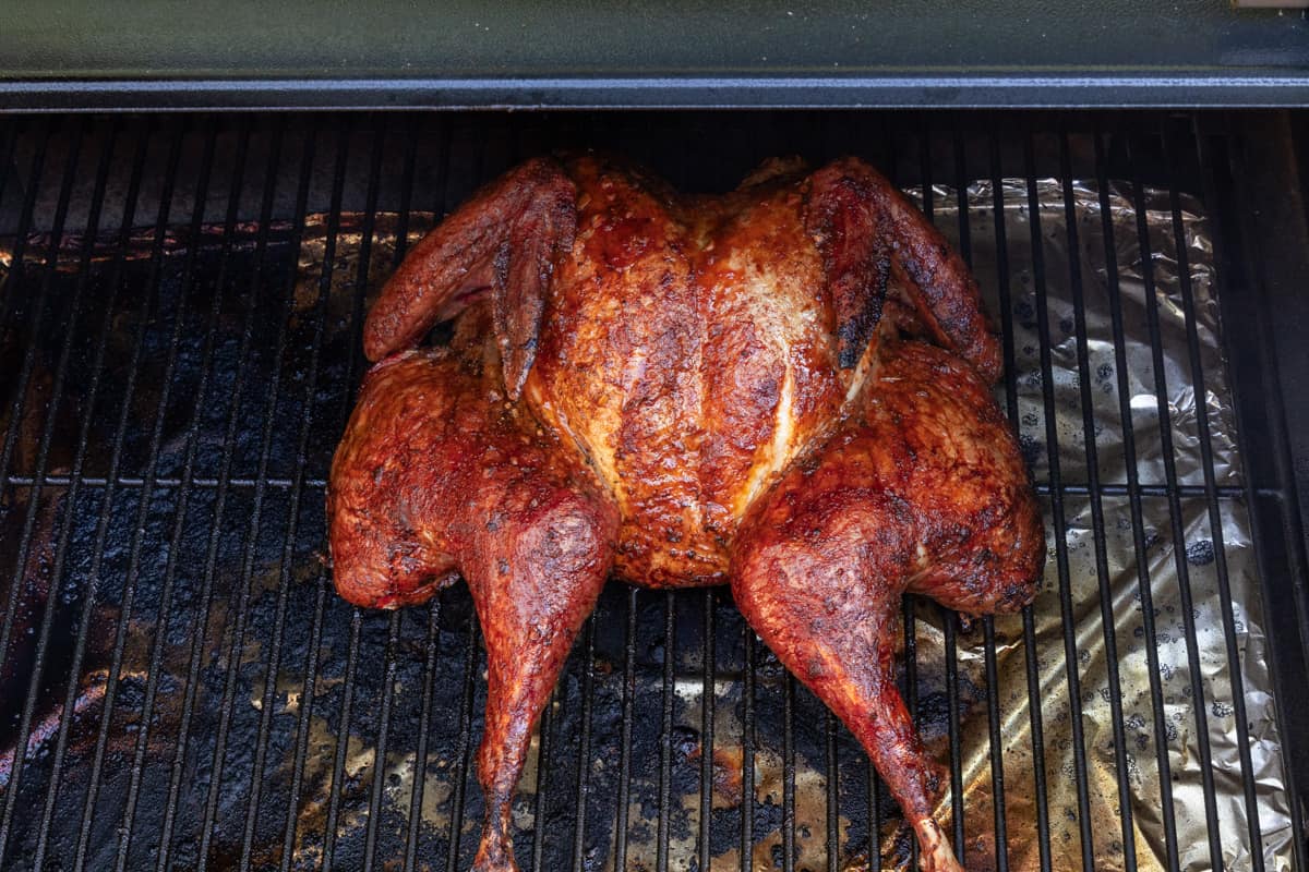 Spatchcock turkey on grill rack finished smoking/cooking.